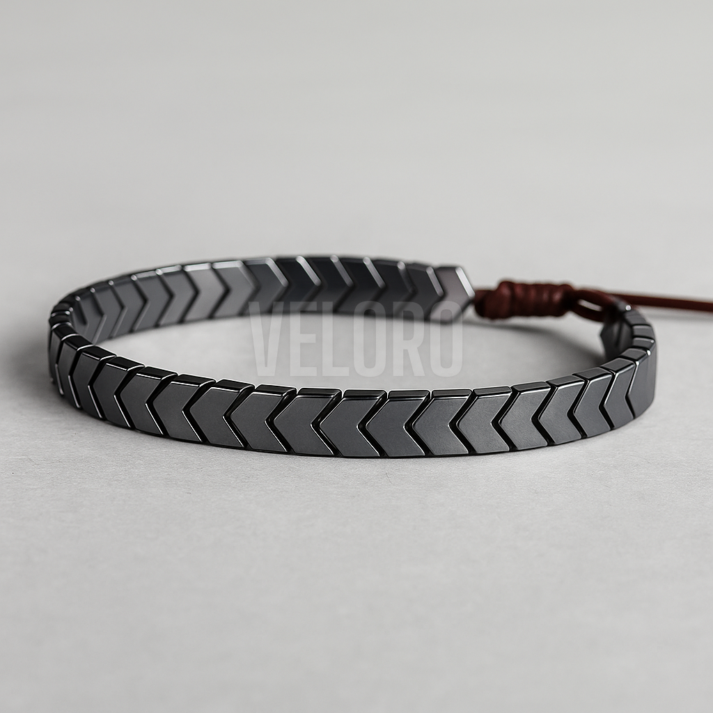 Black chevron patterned bracelet on a light gray background veloro