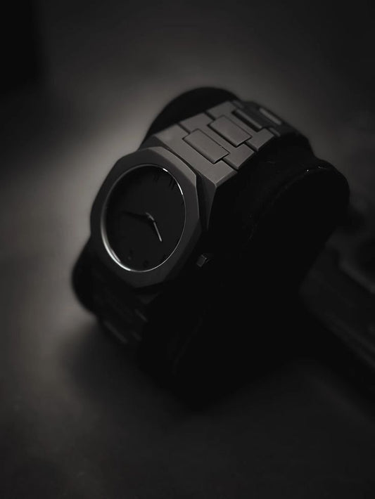 Veloro Aura Black Luxury Watch with sleek matte finish and minimalist design, displayed on a black cushion – premium men’s timepiece.