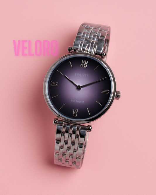Silver watch with a purple face on a pink background, featuring the brand 'Veloro'.