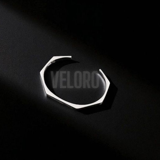 Silver ring with 'VELORO' branding on a black background VELORO
