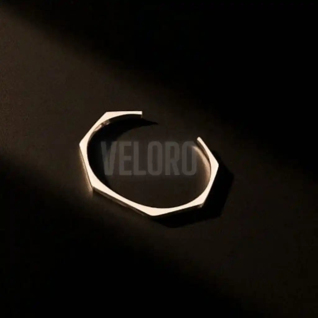 hexagonal geomatric bangle Metallic  on a black background with 'VELORO' branding.