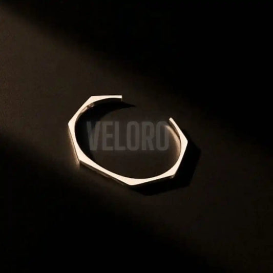 hexagonal geomatric bangle Metallic  on a black background with 'VELORO' branding.